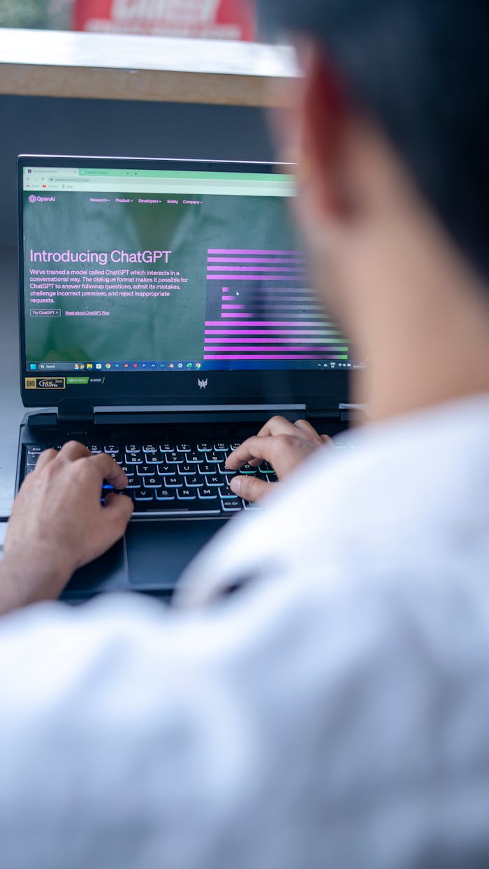 who-we-are Focused shot of a man using ChatGPT on laptop. Ideal for tech-related content.