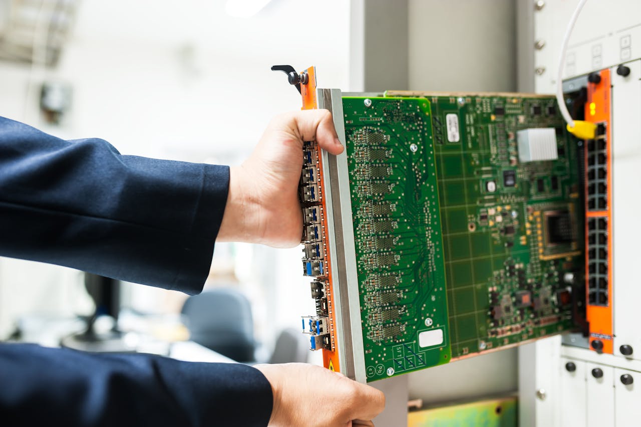 about-hero A technician inserts a circuit board into a server rack, illustrating technology and connectivity.
